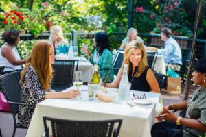 Ladies drink wine on the patio at Town 220