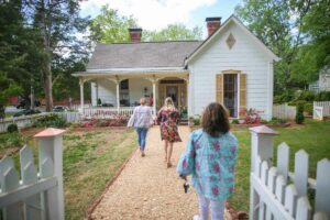 People tour a cottage in Madison, GA