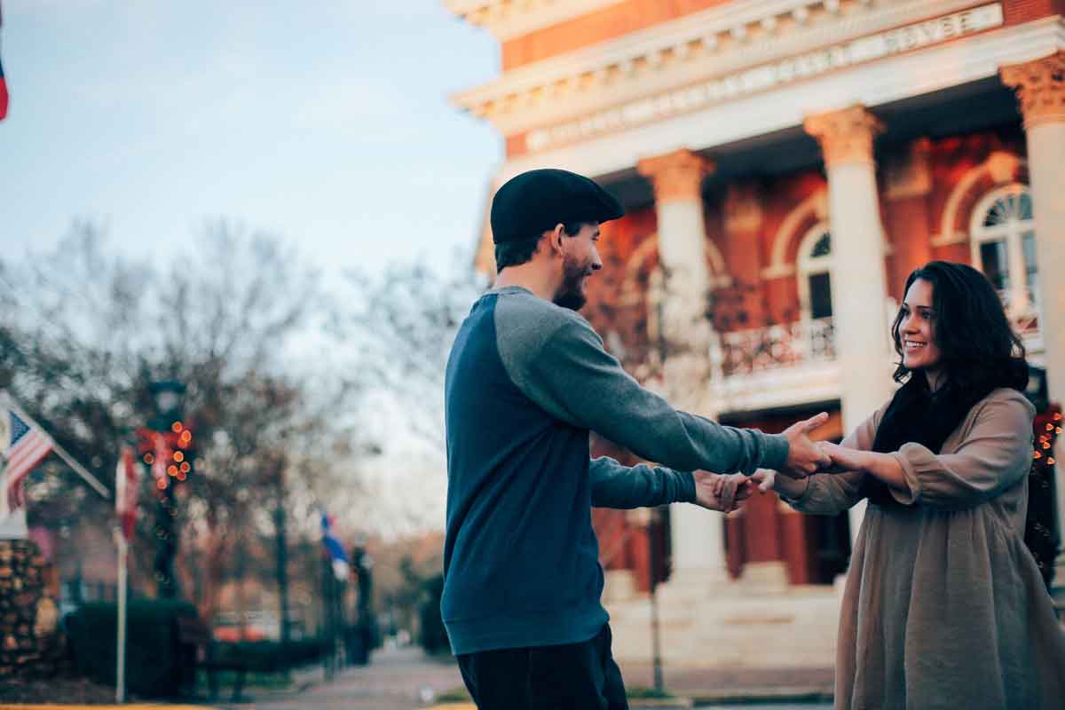 A couple holds hands in front of the Morgan County Courthouse during the holidays.