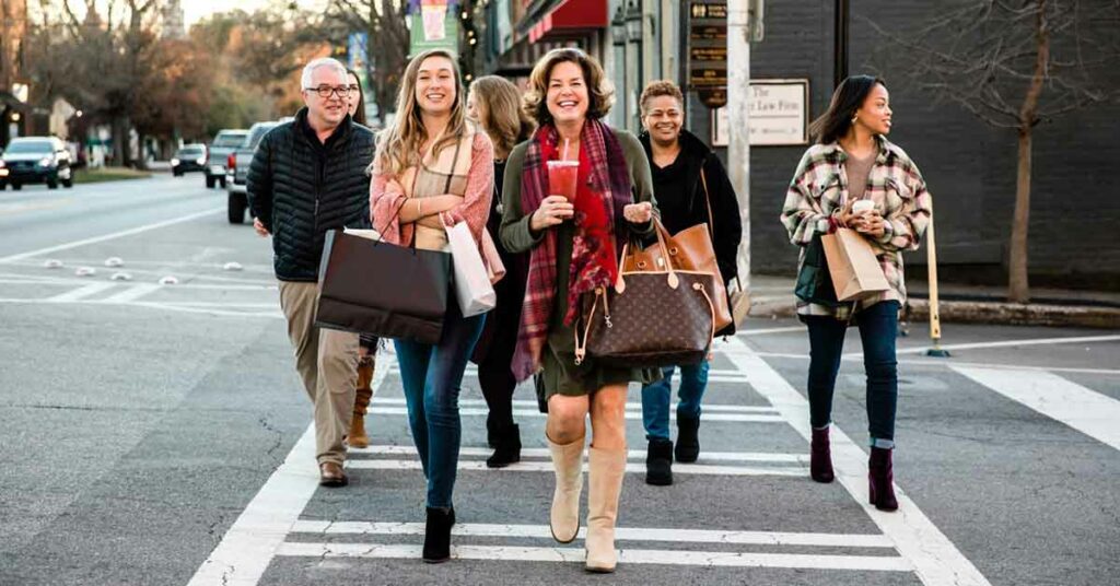 Holiday shoppers cross the street in downtown Madiison, Georgia