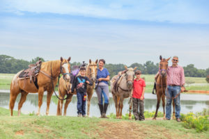 Family with horses beside pond at Southern Cross Guest Ranch | Georgia Attractions | Things to Do in Madison Georgia | Visit Madison GA