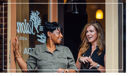 Two women exit the Salon at The James Madison Inn