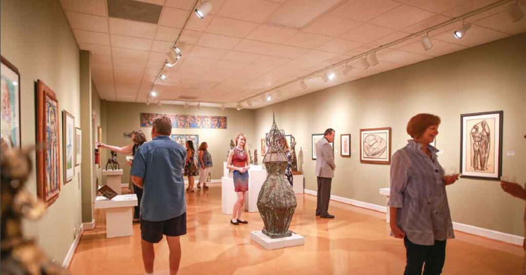 People view an exhibit at Steffen Thomas Museum of Art