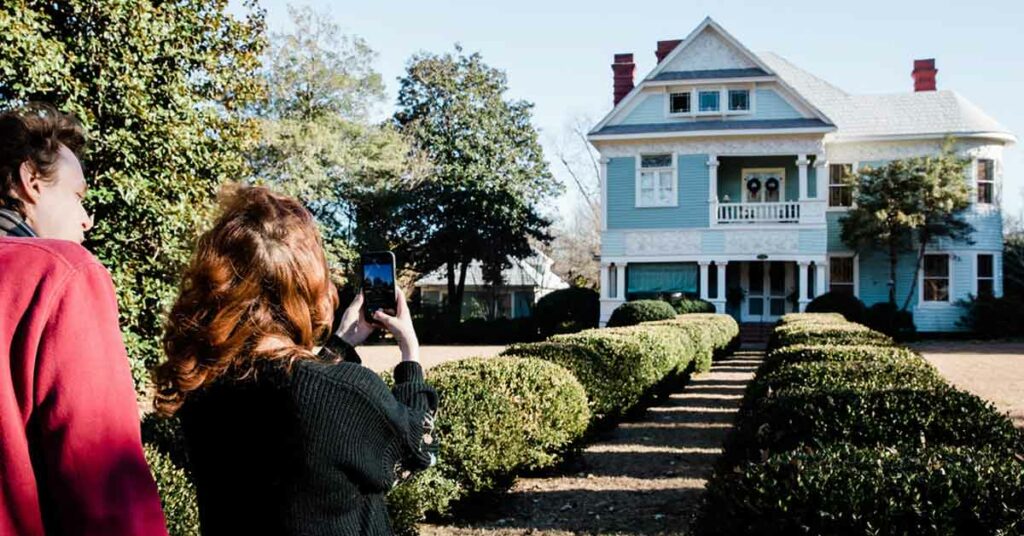Couple admires historic homes during their small town Christmas vacation