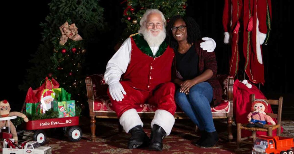 Santa taking photos with visitors during their Christmas vacation