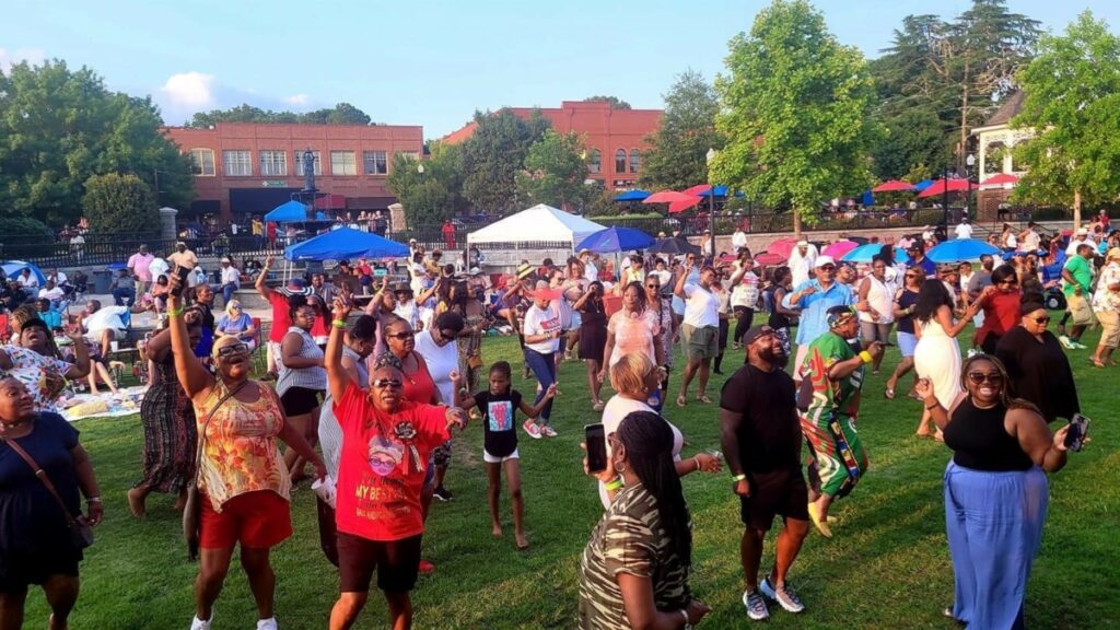 "People dancing in Madison Town Park at the We Are One Music Fest."