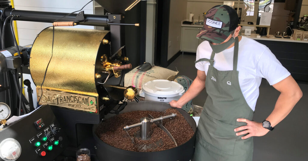 Jin roasts coffee beans in store at Oconee Coffee Roasters - one of Madison's unique coffee shops