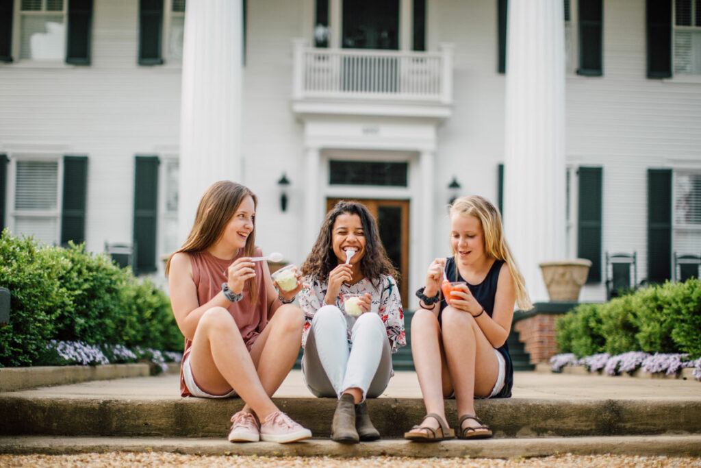Girls eating ice cream in front of a historic home | Madison GA Shopping | Official Tourism Site For Madison GA | Visit Madison GA