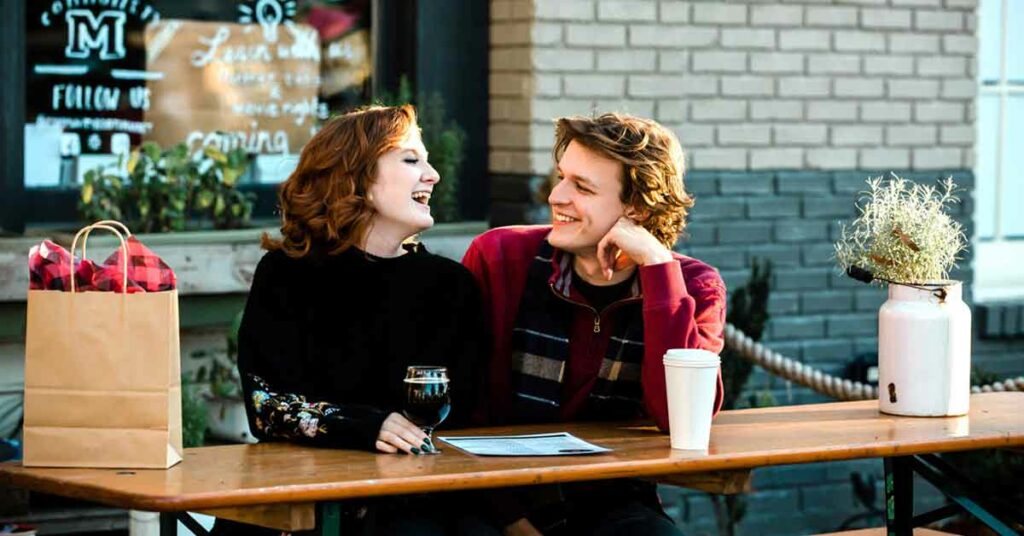 Young couple enjoying beverages on a patio