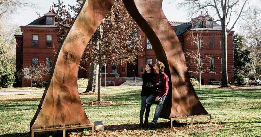 A couple admires the lawn art at the Madison-Morgan Cultural Center