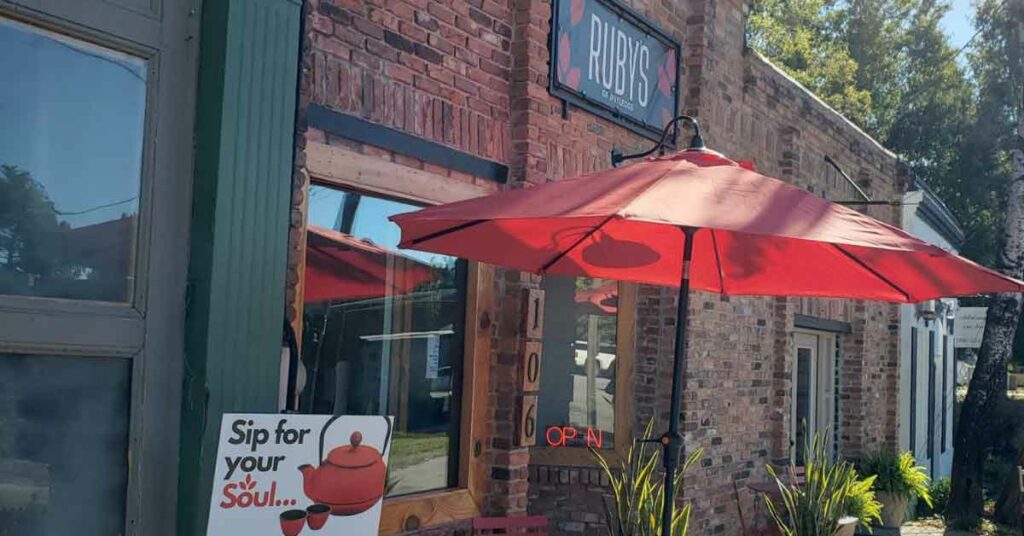 Ruby's of Rutledge outdoor table and red umbrella