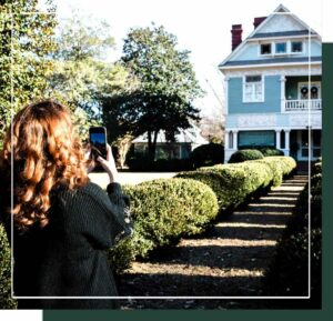 Woman taking a photo of the Magnolia House