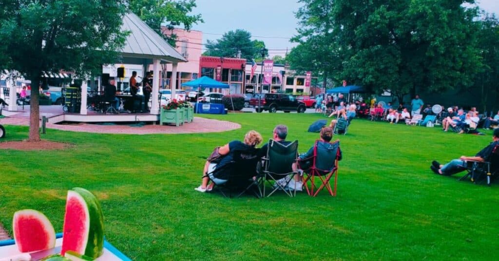 People listen to musicians at the Rutledge Summer Concert Series - a wonderful last-minute summer vacation.