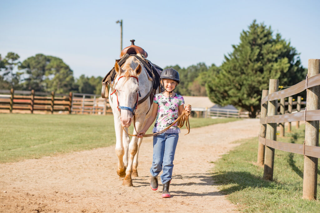 Girl and a horse at Southern Cross Guest Ranch | Family Vacation: 5 Fun Things to Do with Kids in Madison, GA | Madison GA Family Vacation | Official Tourism Site For Madison GA | Visit Madison GA
