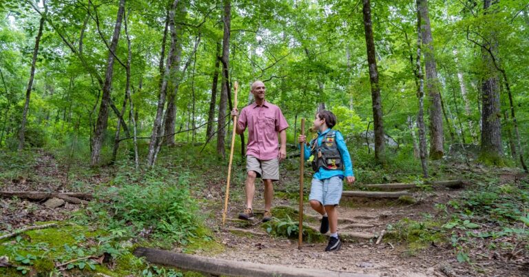 Family with kids hiking at family friendly Hard Labor Creek State Park on Family Vacation. One of the best things to do with kids and one of the best summer vacations for families.