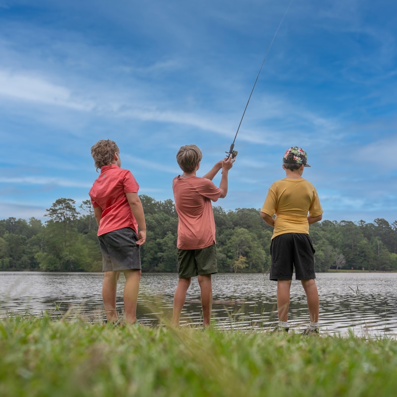Three boys fishing in Lake Rutledge. Outdoor Recreation in Madison, Georgia.